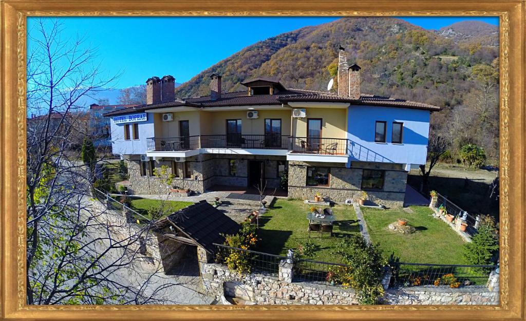 a picture of a house in front of a mountain at Voreas Hotel in Kato Loutraki