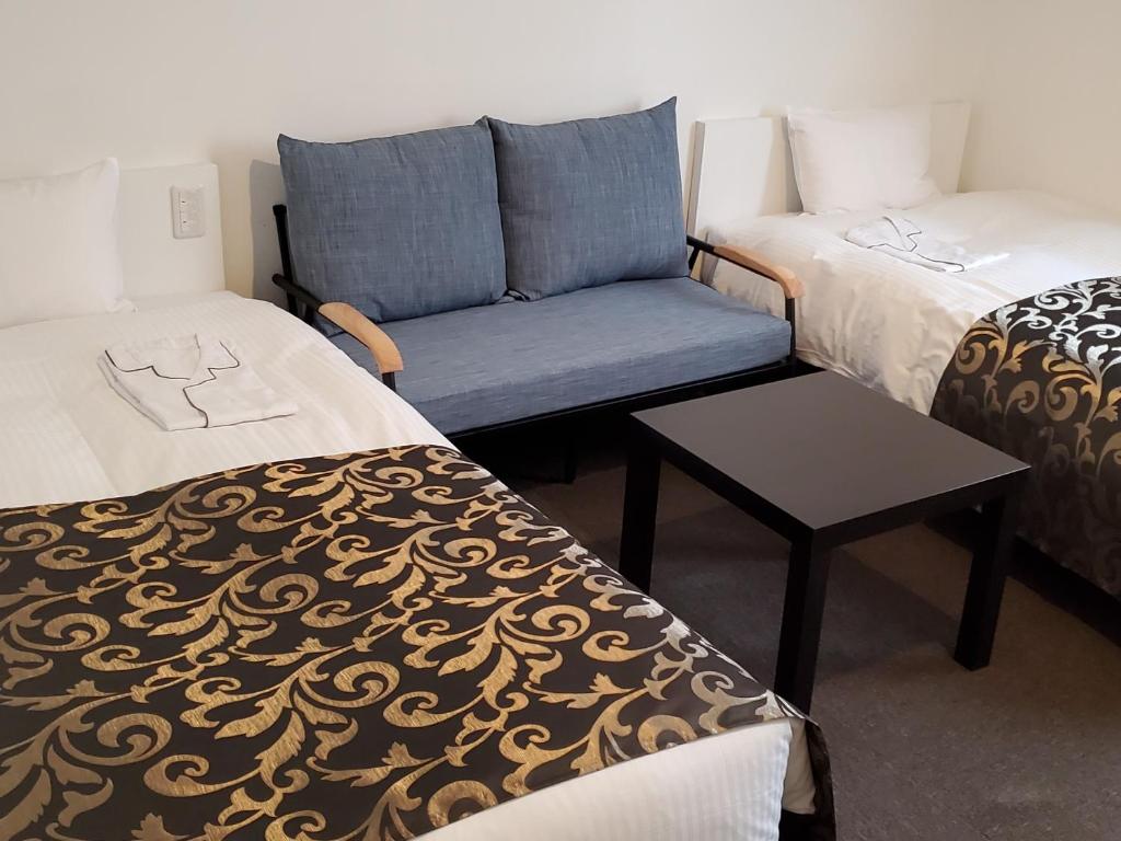 Postel nebo postele na pokoji v ubytování Tachikawa Regent Hotel