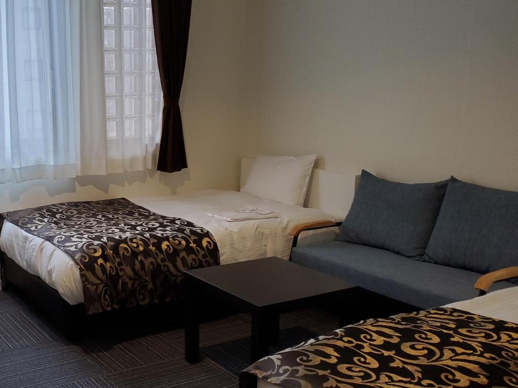 Postel nebo postele na pokoji v ubytování Tachikawa Regent Hotel