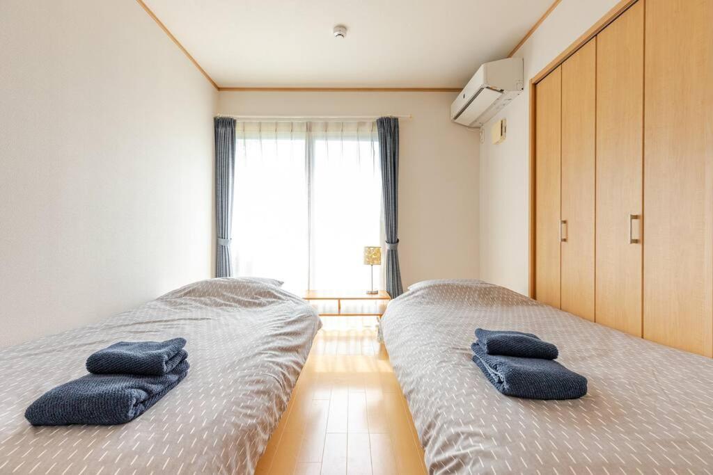 Postel nebo postele na pokoji v ubytování 湯河原 Hama no ie