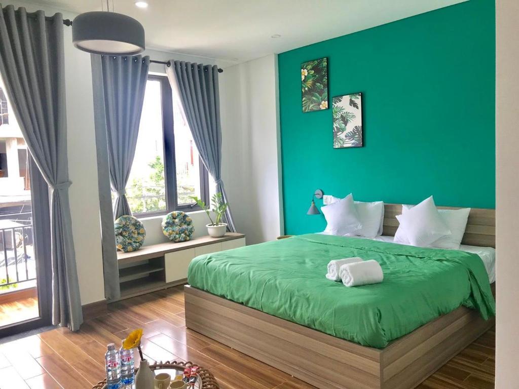 Postel nebo postele na pokoji v ubytování Kivi Homestay Hoi An