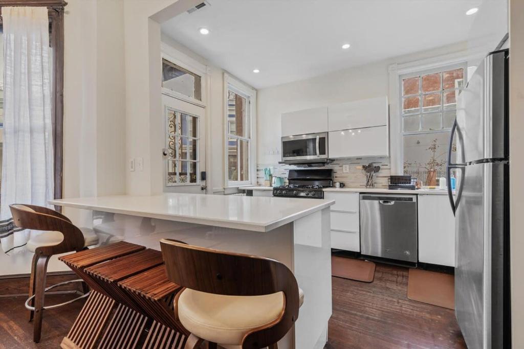a kitchen with a counter and a refrigerator at 3-BR Historic Home Nestled Btw Petworth & CoHi in Washington, D.C.