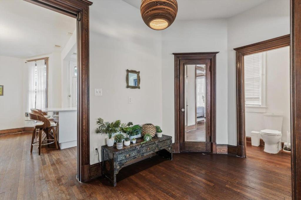 a large mirror in a living room with wooden floors at 3-BR Historic Home Nestled Btw Petworth & CoHi in Washington, D.C.