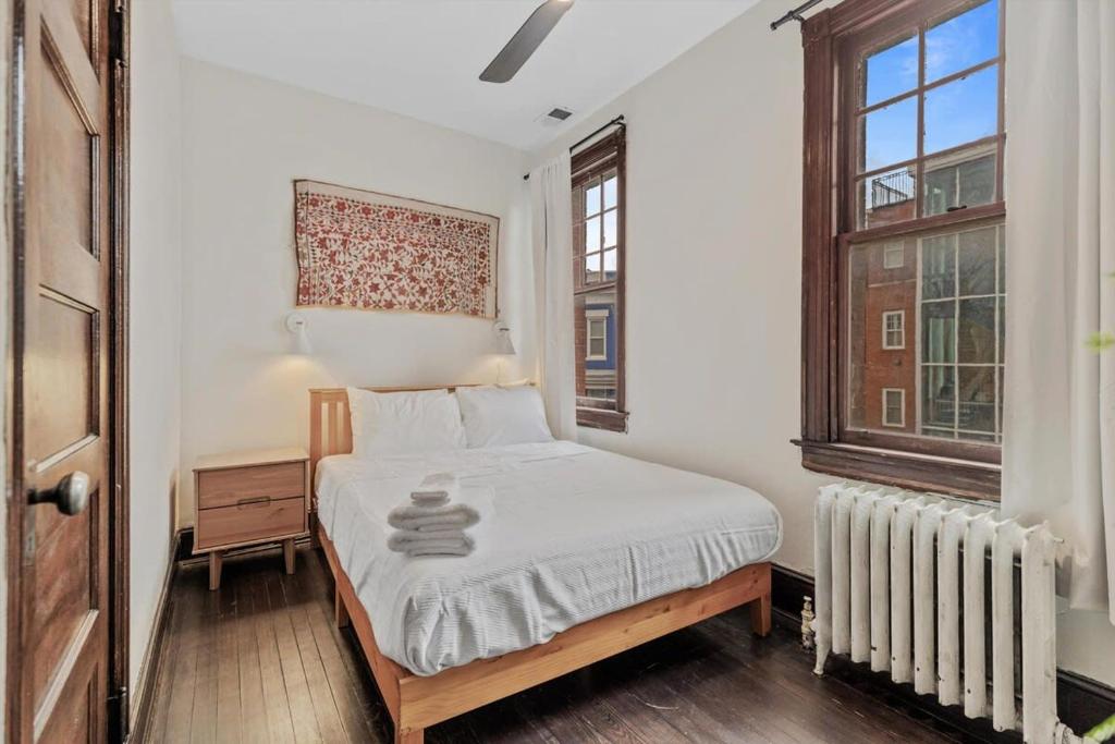 a white bedroom with a bed and a window at 3-BR Historic Home Nestled Btw Petworth & CoHi in Washington, D.C.