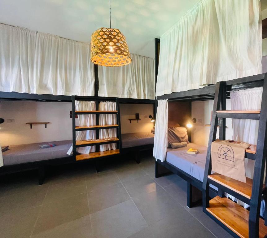 Postel nebo postele na pokoji v ubytování MAAYONG HOSTEL