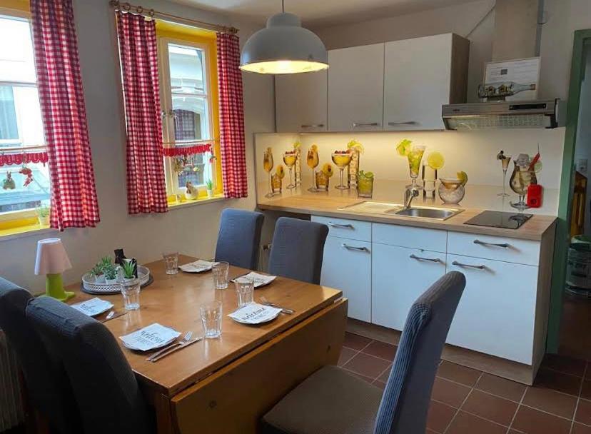 a kitchen with a wooden table with chairs around it at Ferienhaus Anno 1650 in Detmold