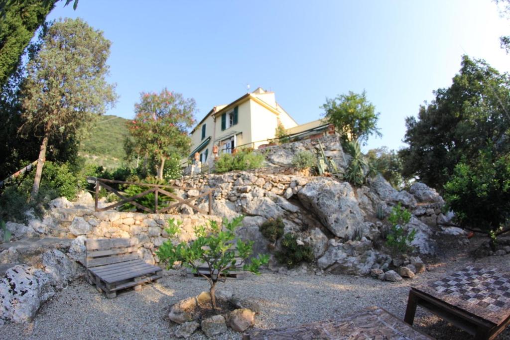a house sitting on top of a rocky hill at Ai Cinque Campanili in Finale Ligure