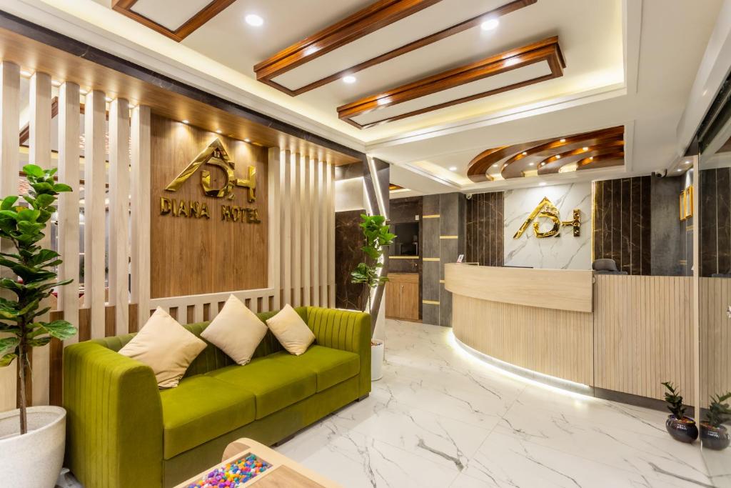 a lobby of a hotel with a green couch at Airport Diana Hotel in Kathmandu
