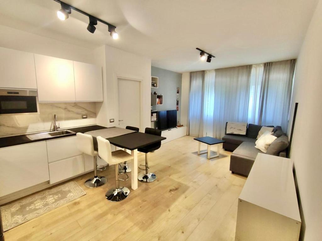 a kitchen and living room with a table and a couch at Venezia Home in Rovereto