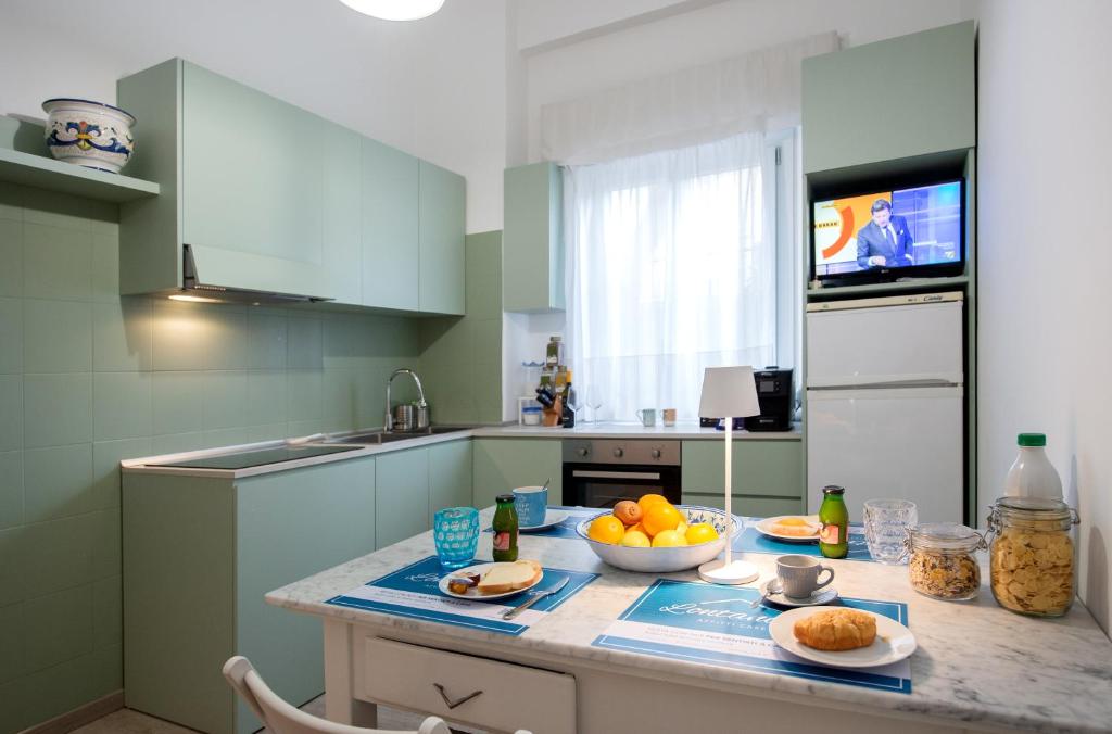 a kitchen with a counter with a bowl of fruit on it at Frog 30 in Gabicce Mare