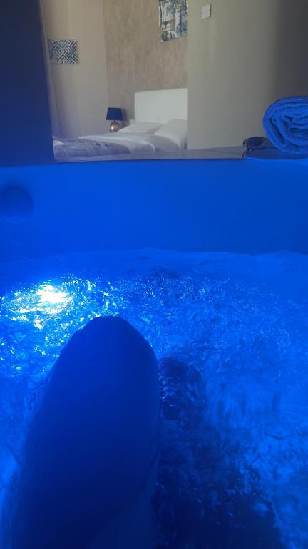 a person swimming in a pool with blue lights at Mael Superior Room in Palermo