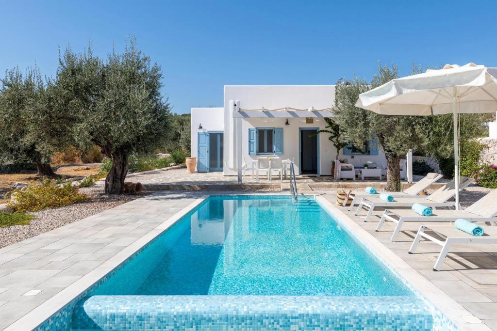 a villa with a swimming pool and a house at Villa Kalathos Dream Galazio in Kalathos