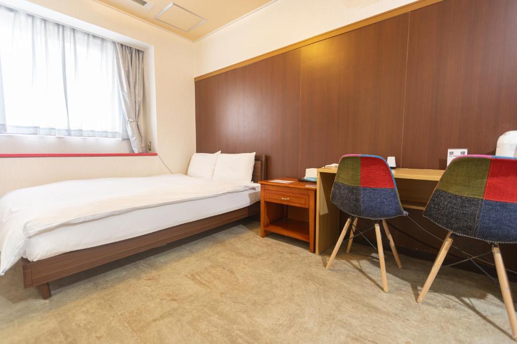 Postel nebo postele na pokoji v ubytování Miro Hotel Dotonbori