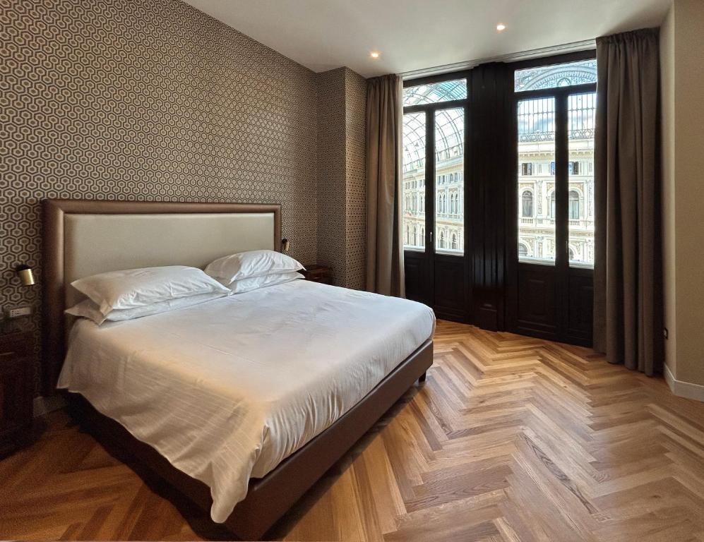 Łóżko lub łóżka w pokoju w obiekcie Caruso Place Boutique & Wellness Suites