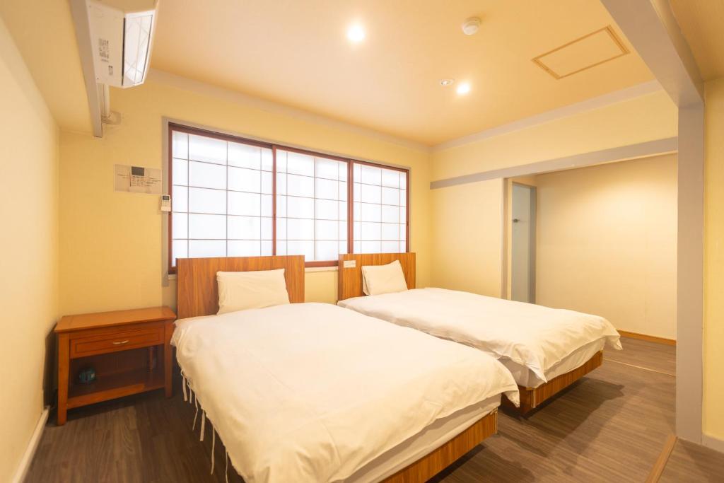 Postel nebo postele na pokoji v ubytování Miro Hotel Dotonbori