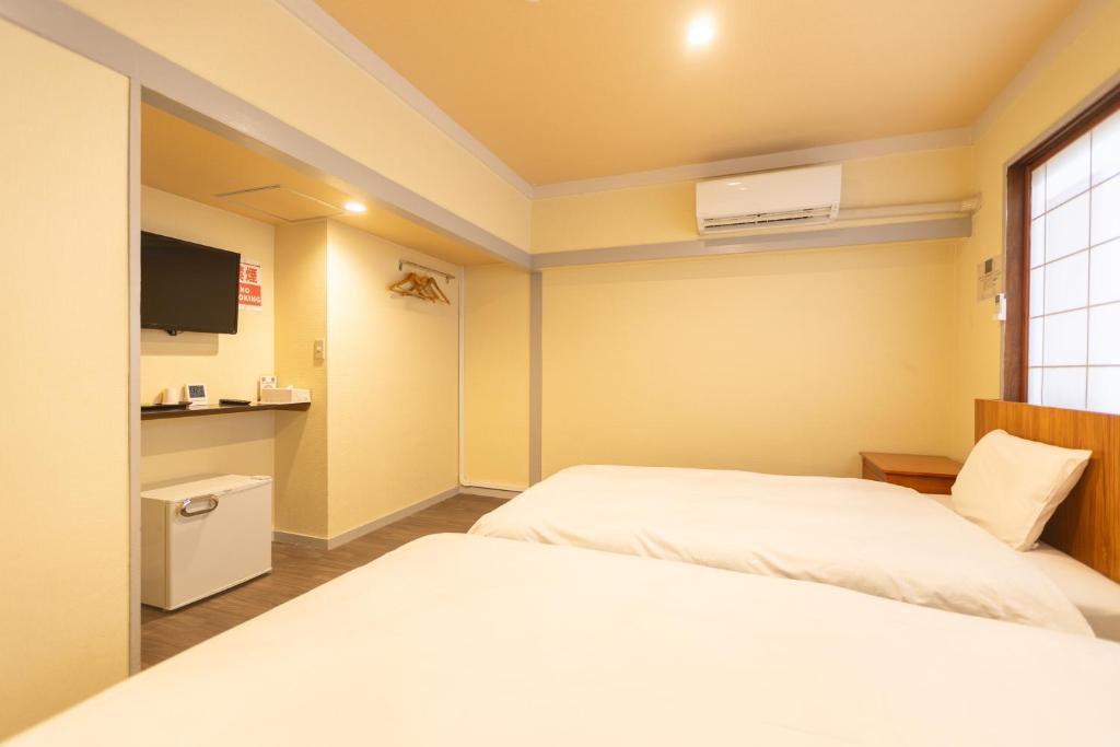 Postel nebo postele na pokoji v ubytování Miro Hotel Dotonbori