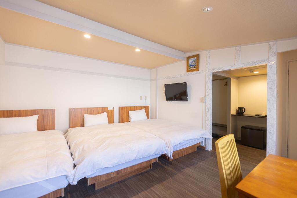 Postel nebo postele na pokoji v ubytování Miro Hotel Dotonbori