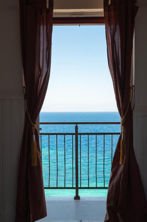 a room with a window with a view of the ocean at Sunrise in Kokkari