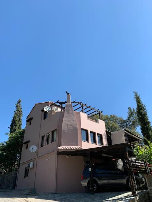 a house with a car parked in front of it at Elis studio luxury apartment in Ierapetra