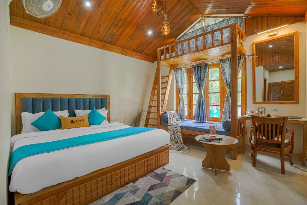 a bedroom with a bed and a desk and a chair at Pax Hotel Rock Villa Swimming Pool Available Dalhousie in Dalhousie