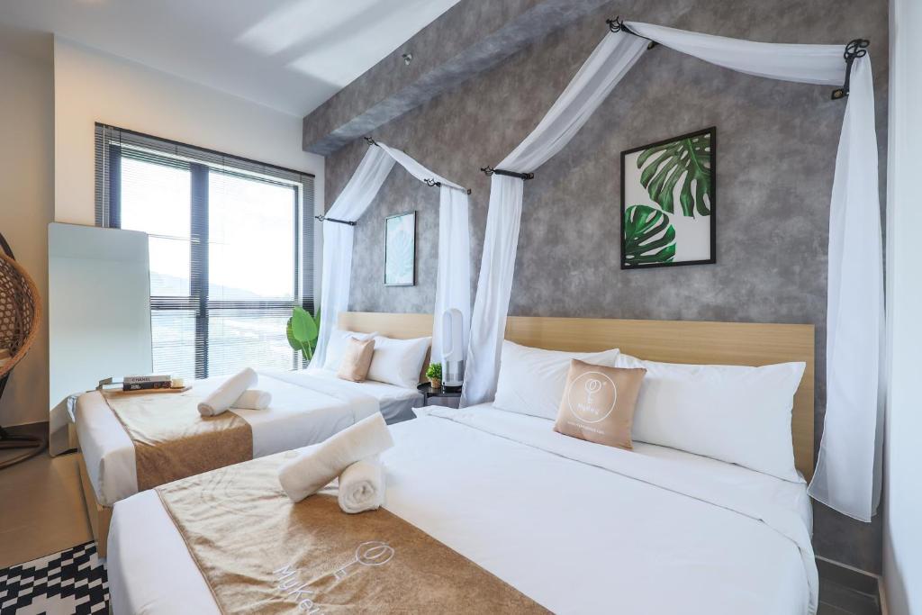 a bedroom with two beds and a large window at Mossaz Suites by MyKey in Petaling Jaya