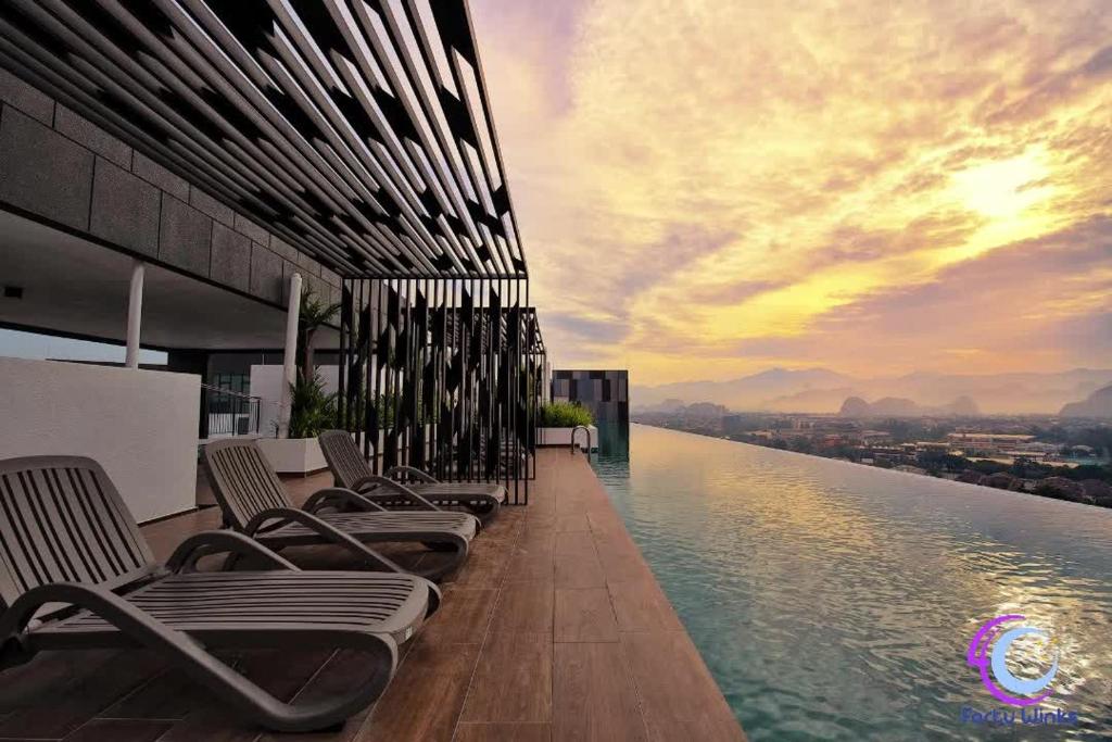 a row of chairs sitting on the edge of a building at The Horizon Ipoh by 40 Winks in Ipoh
