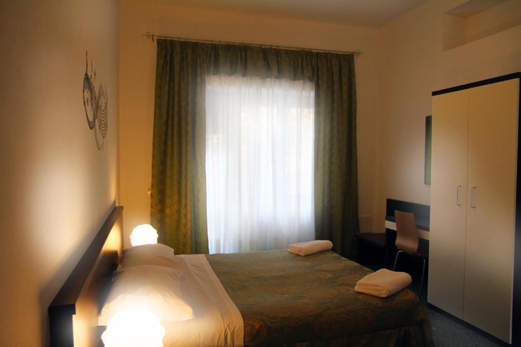 a bedroom with a bed and a large window at B&B Music in Milan