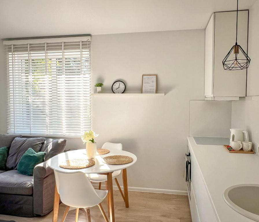 a kitchen and living room with a table and a couch at Oakwood park apartment in Kaunas