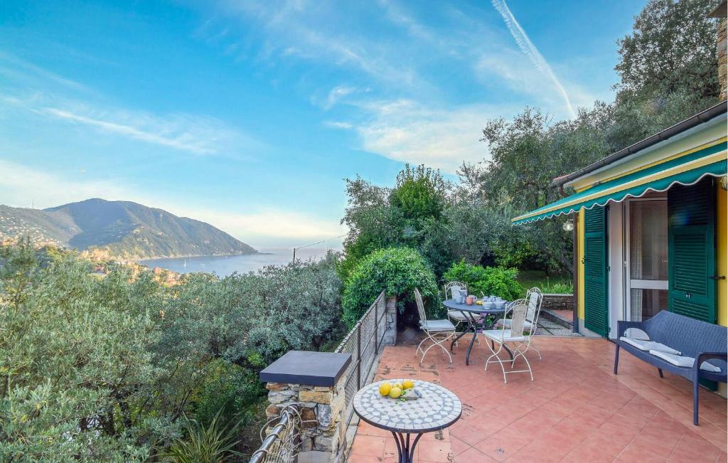 a house with a patio with a table and chairs at Lovely Home In Recco With Wifi in Recco