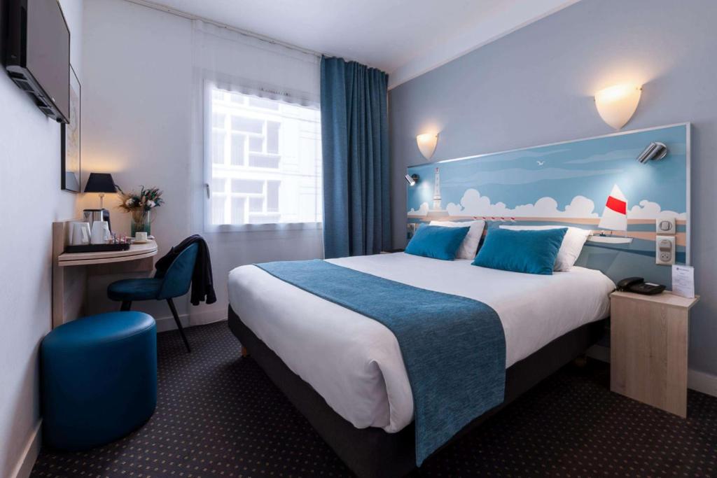 a hotel room with a large bed and a desk at Best Western Hôtel Royan Océan in Royan