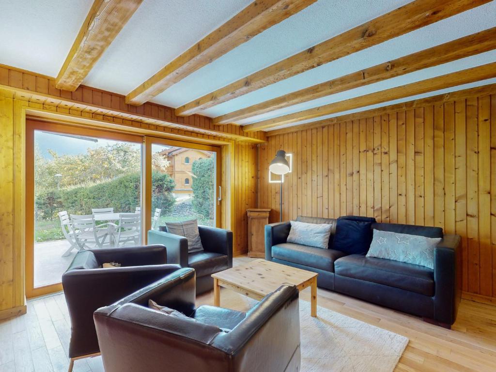 a living room with two couches and a table at Flat with panoramic view, Bèla Yoûva #1 in Crans-Montana