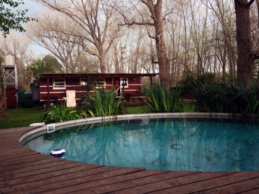 a pool on a deck with a house in the background at Salida de las Casillas in Ingeniero Maschwitz