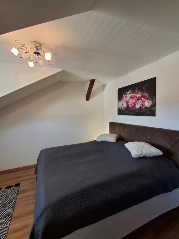 a bedroom with a black bed in a room at Krásny podkrovný 3-izbový byt v širšom centre BREZA in Martin
