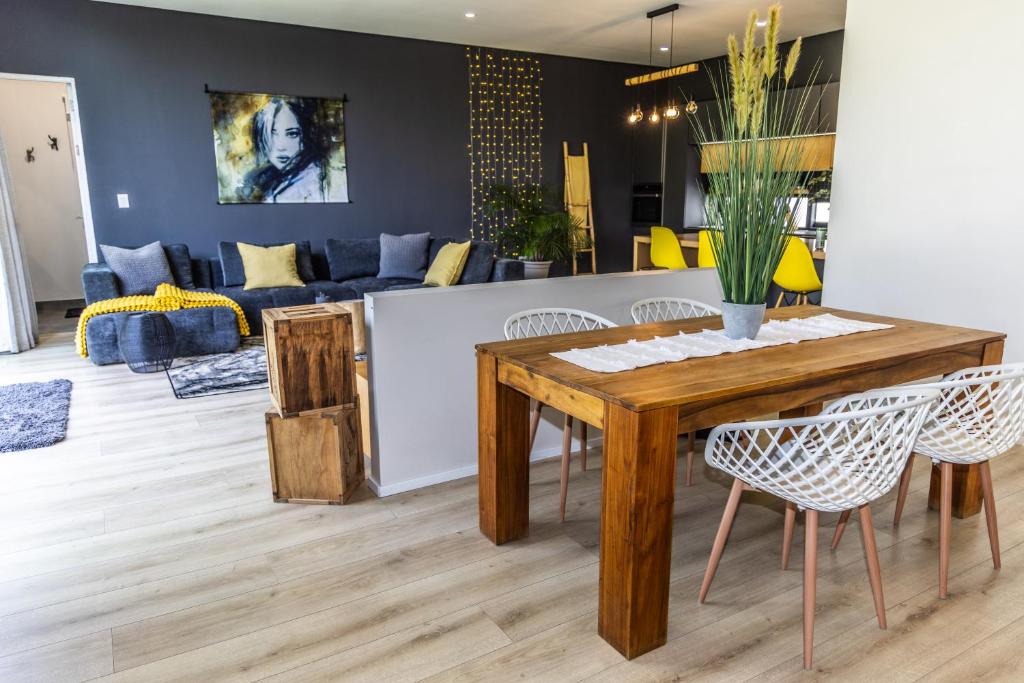 a living room with a wooden table and chairs at 4 Lulworth in Johannesburg