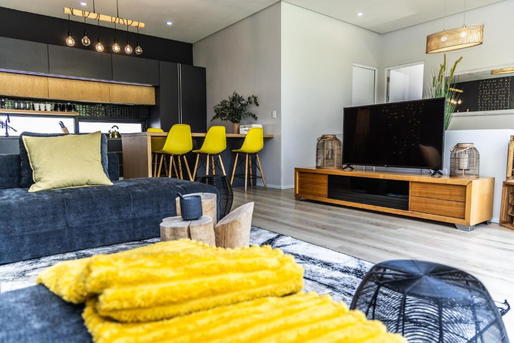 a living room with a couch and a tv at 4 Lulworth in Johannesburg