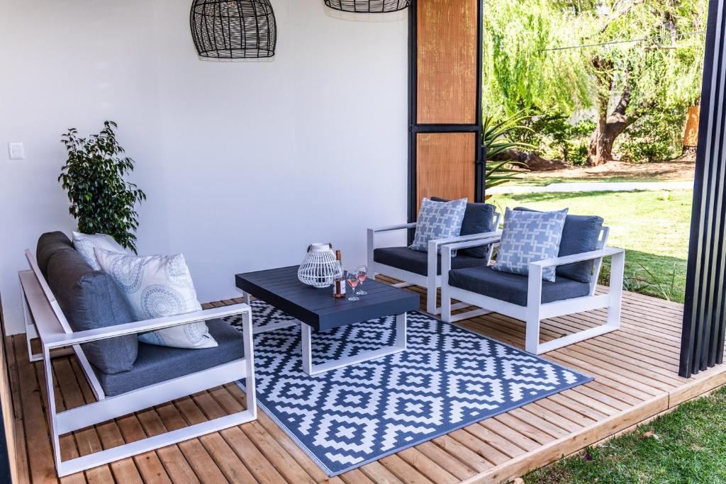 a patio with two chairs and a table on a deck at 4 Lulworth in Johannesburg