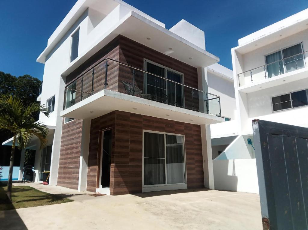 a large white house with a balcony at villa caraibica piscina privata in Sosúa