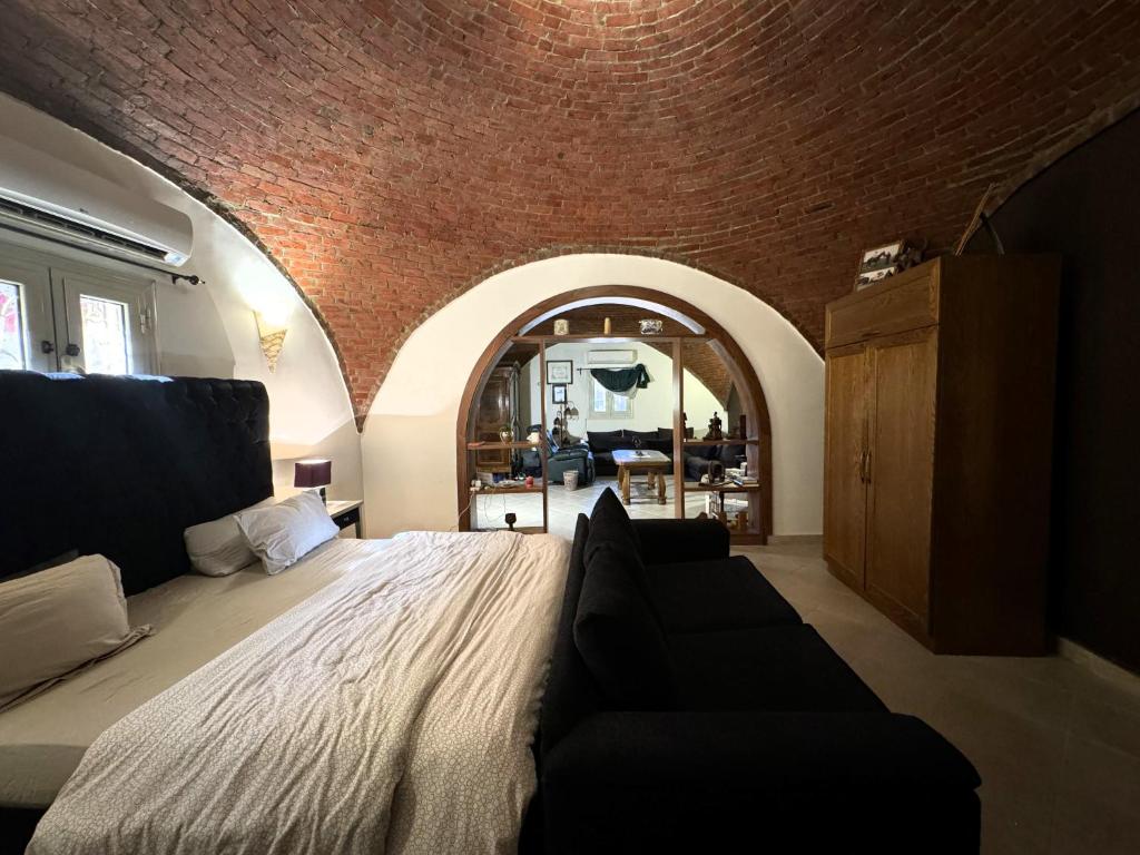 a bedroom with a bed and a couch in it at 1-Bedroom Guesthouse in Giza