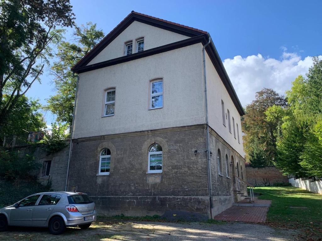 a house with a car parked in front of it at Ferienwohnung Bad Kösen in Bad Kösen