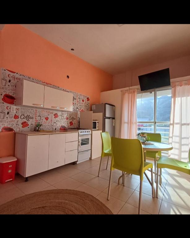 a kitchen with a table and chairs and a dining room at Hospedaje Martina in Belén