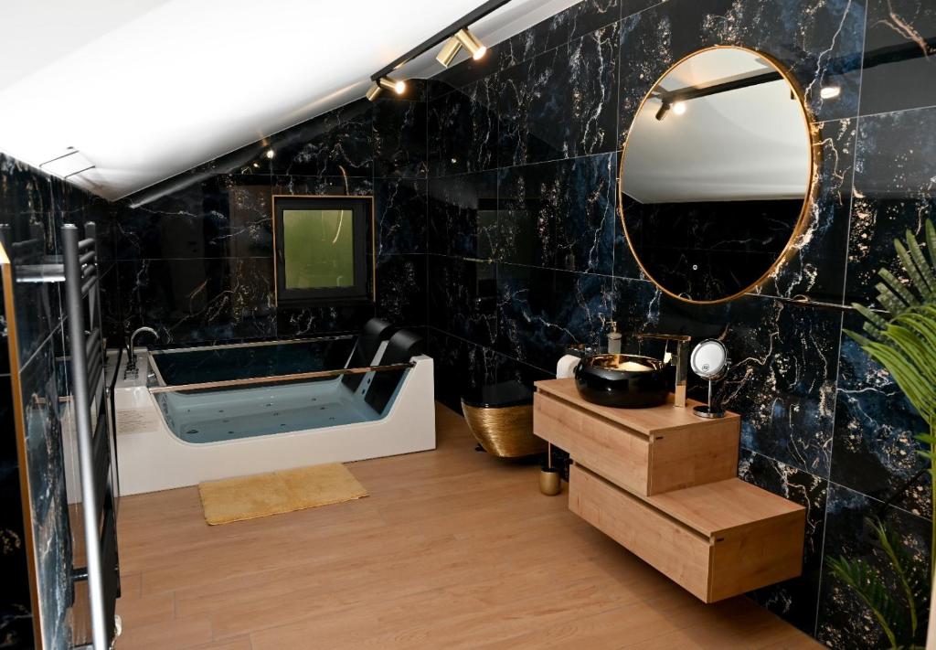 a bathroom with a large mirror and a tub at Mery in Slavonski Brod