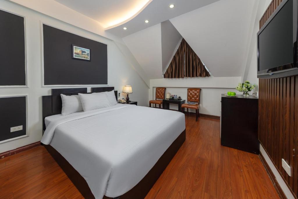 Postel nebo postele na pokoji v ubytování Viet Hotel & Travel