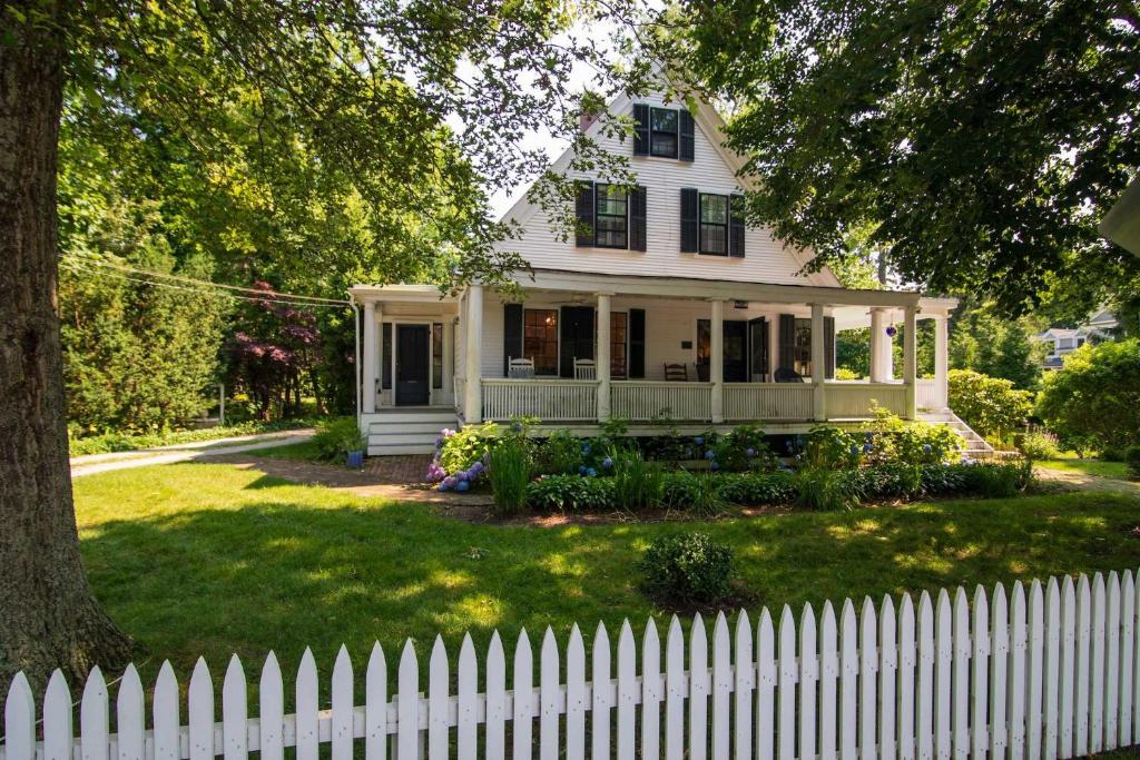 a white fence in front of a white house at Shopping Restaurants 6 mins to Beach AC in Yarmouth