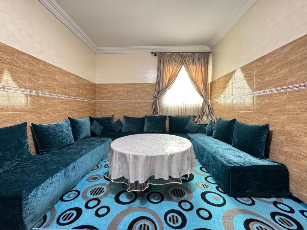a living room with a couch and a table at Cozy & Chic Agadir Netflix, Beach & Comfort in Agadir