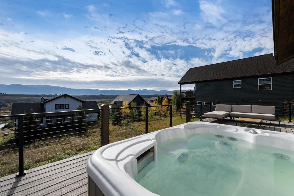 a hot tub on the deck of a house at Scenic Perch home in Tabernash
