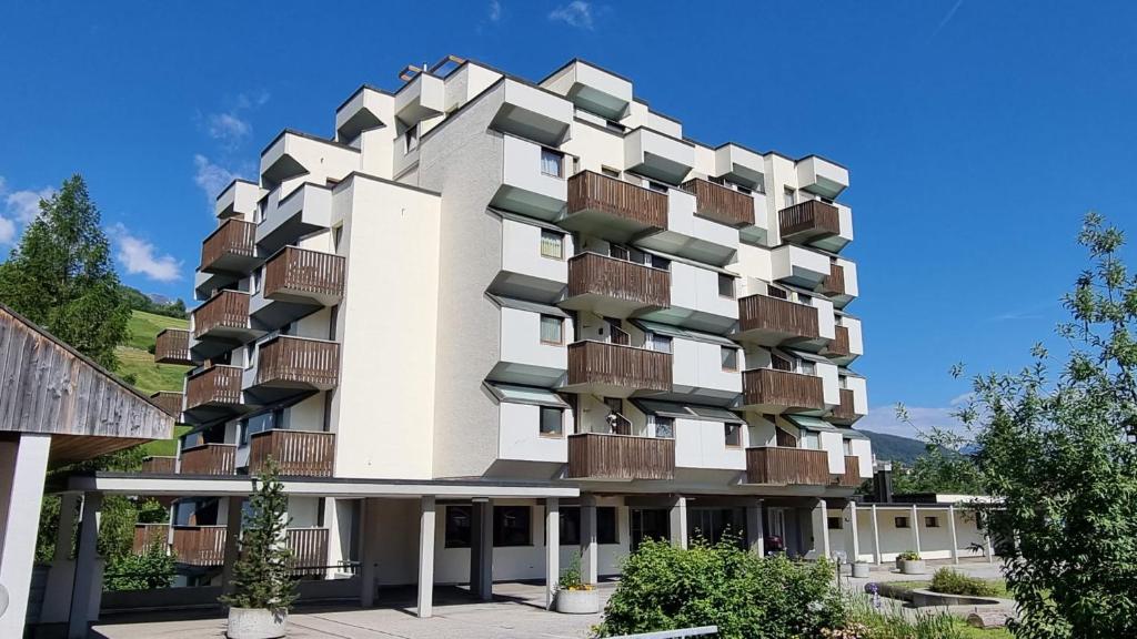 a building with balconies on the side of it at Residenza Tga Clo Apartment 09 in Savognin