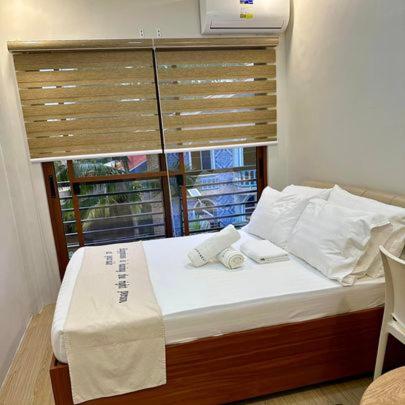 Postel nebo postele na pokoji v ubytování Happynest Rooms in Santa Fe Bantayan Island