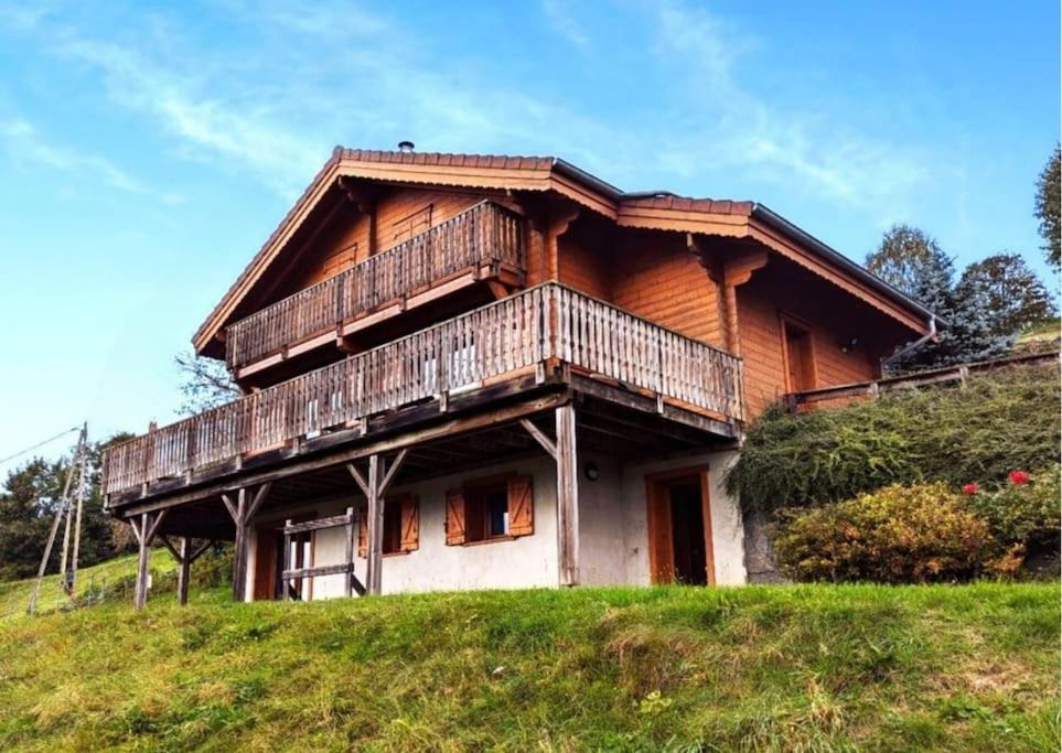 a wooden house on top of a hill at Le Grand Chalet Bellevue - parking Wifi BBQ in La Bresse