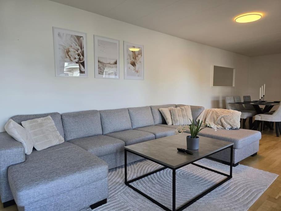 a living room with a couch and a table at Modern and complete House in Västerås