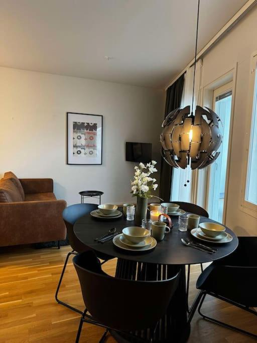 a living room with a table and a couch at 2 hengen unikkosuite in Rovaniemi